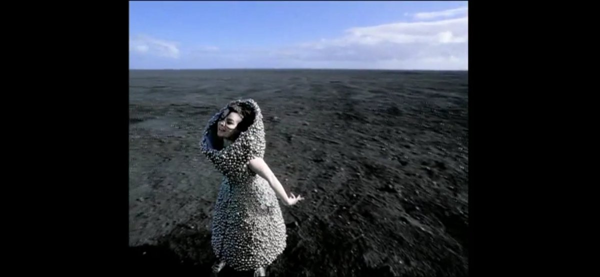Who Is It (2004)In the video, Björk wears a dress made of bells, by Alexander McQueen, and perform the song while accompanied by a group of children, also wearing outfits adorned with bells.