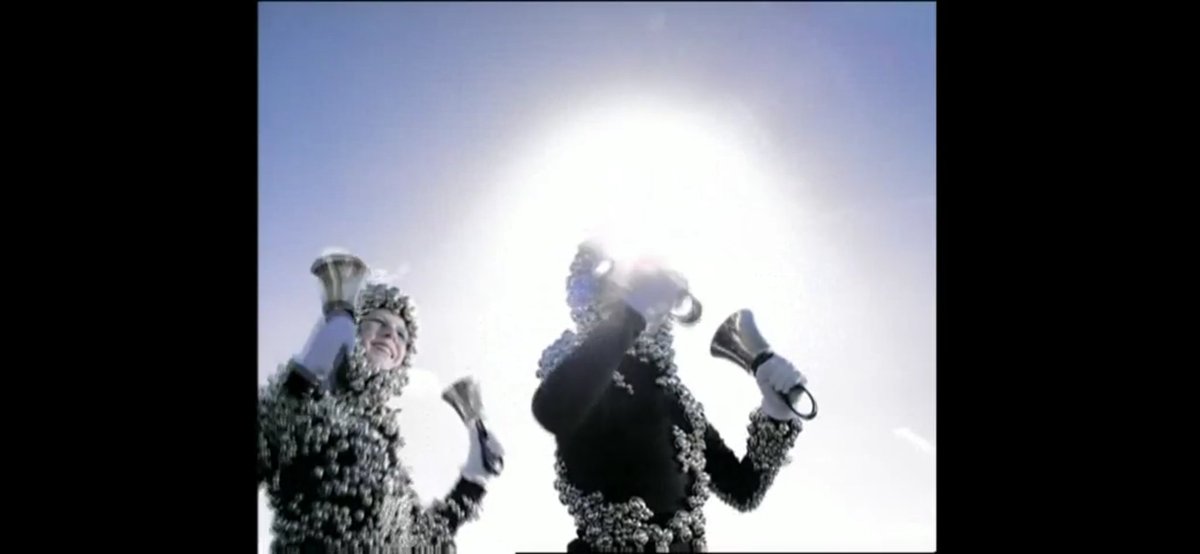 Who Is It (2004)In the video, Björk wears a dress made of bells, by Alexander McQueen, and perform the song while accompanied by a group of children, also wearing outfits adorned with bells.