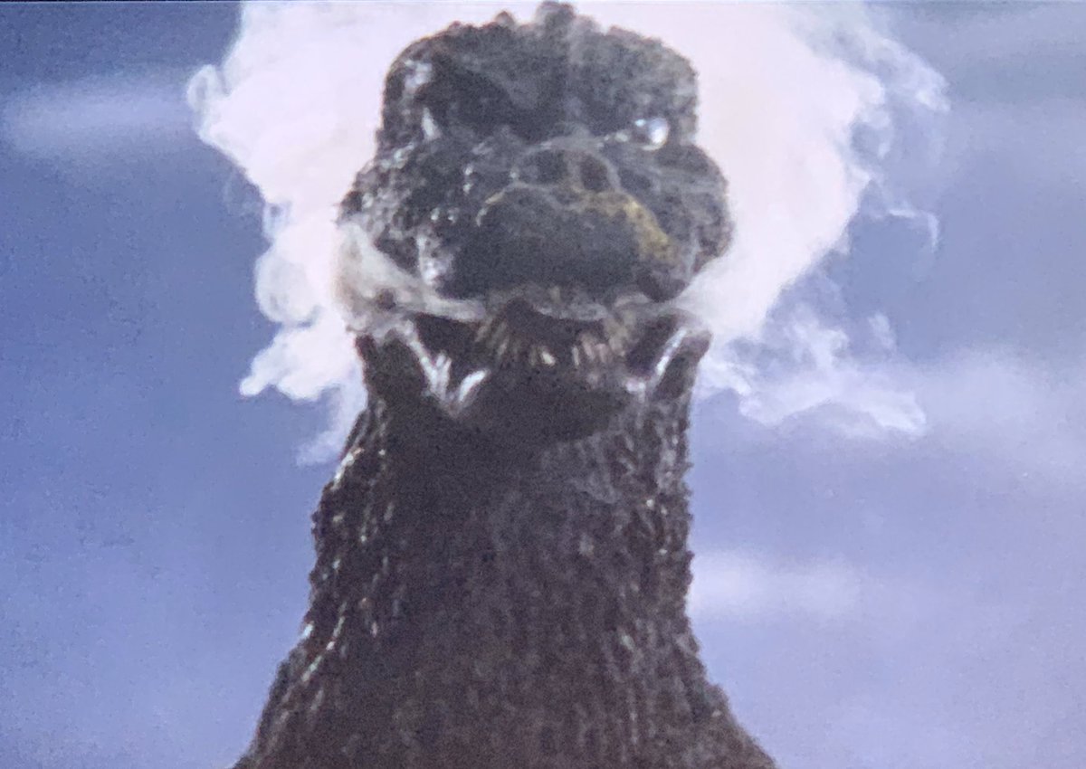 godzilla smoking a cigarette which movie got you like: : r/GODZILLA An illustrated Godzilla smoking two