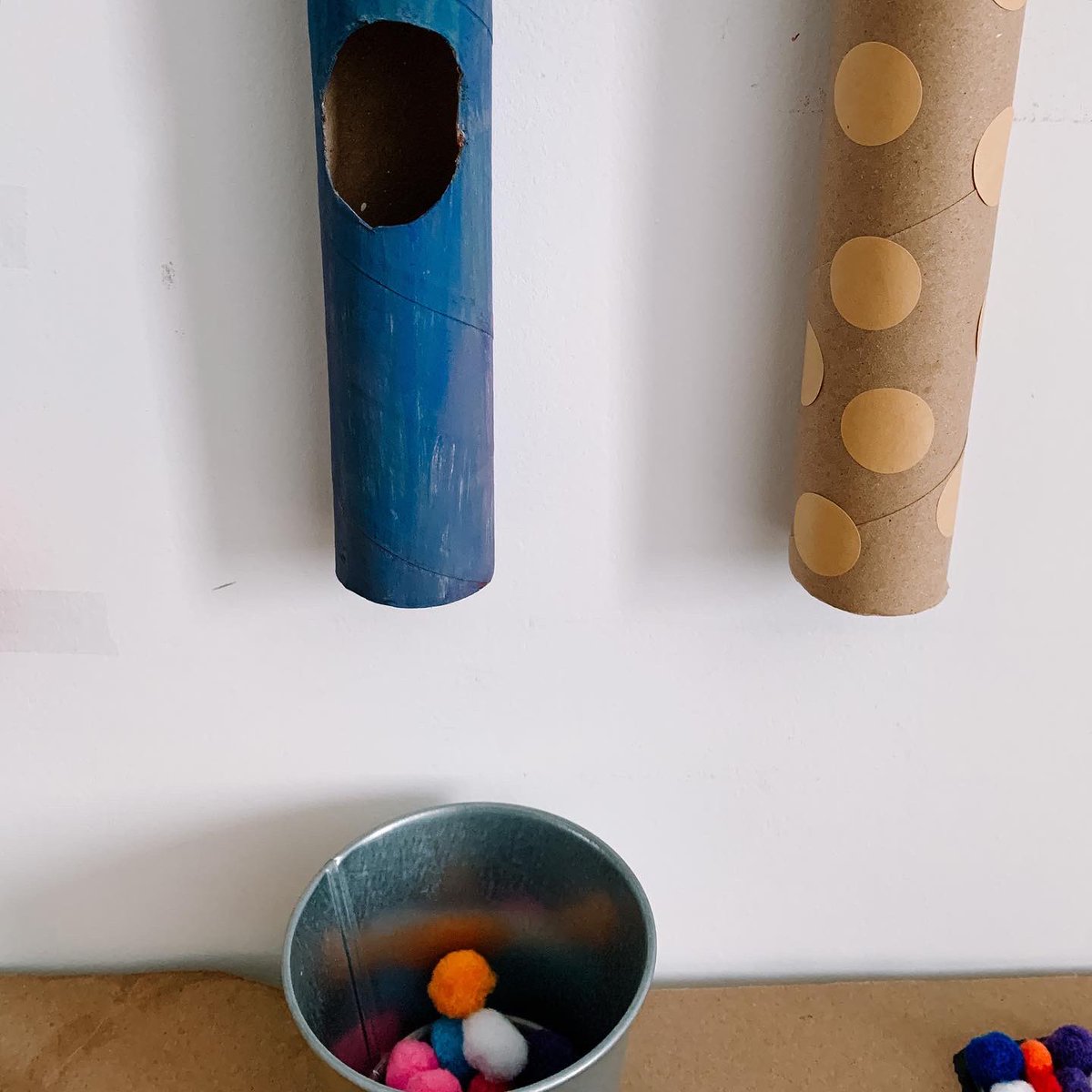 Drop activity using pom pom balls and paper roll. It’s great for helping him develop fine motor skills and an understanding of cause and effect.Pom pom balls can be replaced with something else. Sometimes I used markers.