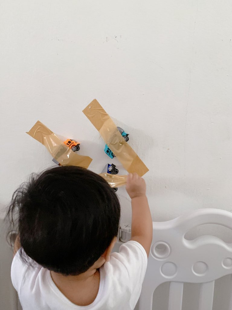 Taped toys is such a fun and easy activity to set up. This activity encourages my baby to works on hand-eye co-ordination and it's amazing the amount of concentration that peeling tape requires.