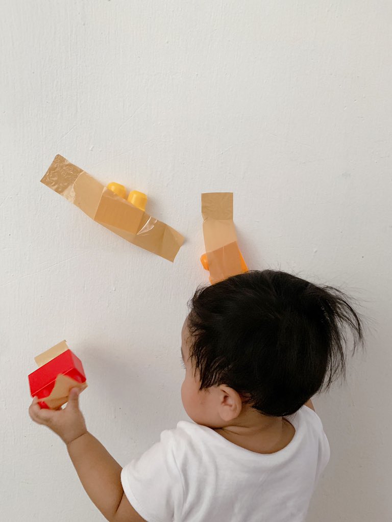 Taped toys is such a fun and easy activity to set up. This activity encourages my baby to works on hand-eye co-ordination and it's amazing the amount of concentration that peeling tape requires.