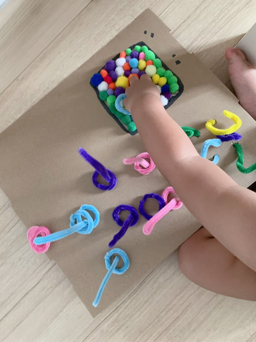 Using chenilles stem sticks for tugging and colour matching activities. Also I’m using pom pom balls and taped them on the cardboard for him to pluck them out. The sticks and pom pom created a wonderful sensory experience too.