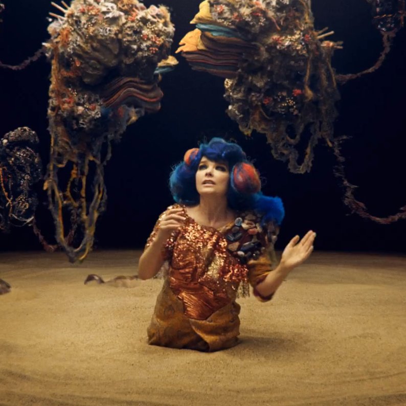 Mutual Core (2012)Commissioned and premiered at the MOCA in Los Angeles, portrays Björk in a sand bed, while various rocks revolve around her. At the end of the video, two rocks unite to form a volcano, which shapes resemble Björk's face features