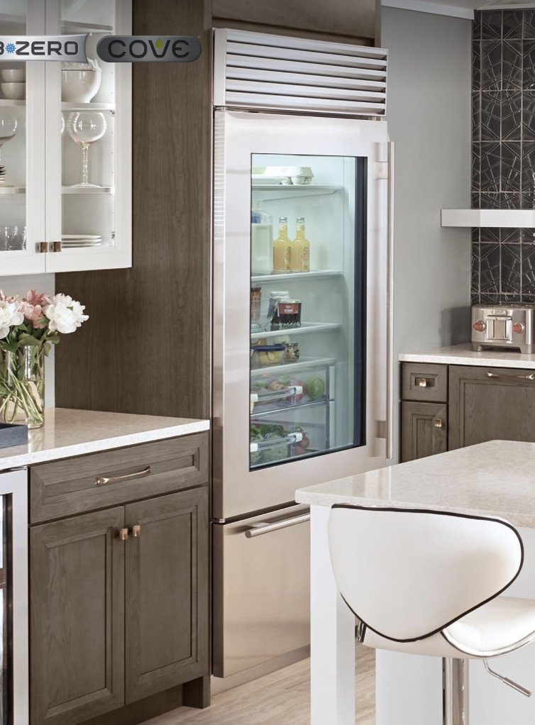 [P] The fridge appears to be Sub-Zero's "36" Classic Over-and-Under Refrigerator/Freezer with Glass Door" model. (Fourth photo is another angle of their kitchen, showing the top grille) MSRP $11,740. 2/  https://www.subzero-wolf.com/sub-zero/full-size-refrigeration/builtin-refrigerators/36-inch-built-in-over-under-glass-door-refrigerator-freezer