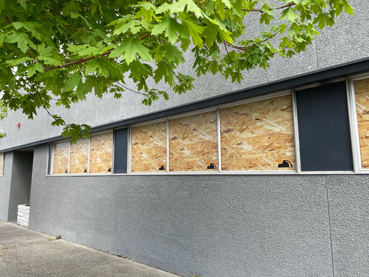 cabel's tweet image. I love that this business took a more budget approach to boarding up their windows for the pandemic. (Also Joby noticed they didn't pay for the stock photo, that's my boy 😭)