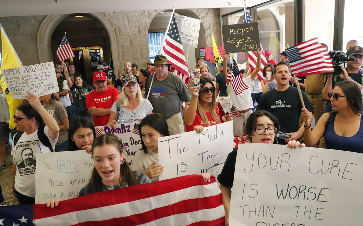 Protesters flood the lobby of the Arizona State Capitol Executive Tower, where Gov. Ducey's office is located, to call for an end to the stay-at-home order.
