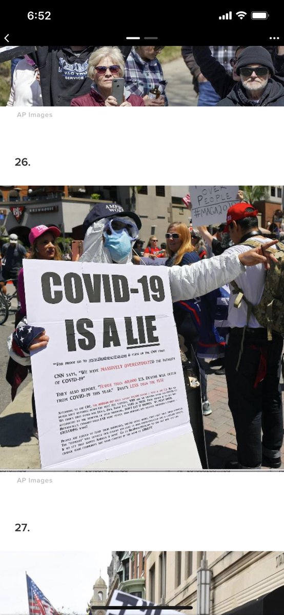 “COVID IS A LIE” -man in a mask and full PPE suit