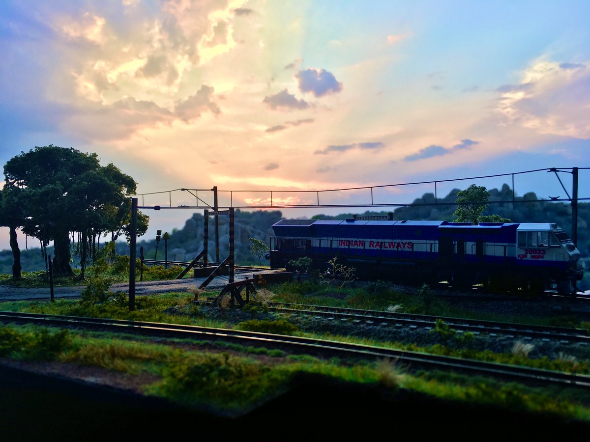 TDioramas's tweet photo. In days like these, what else can be more liberating than a sunset like that! #ModelTrains #ScaleModel #IndianRailways #WDP4 https://t.co/nbgSL94hiE