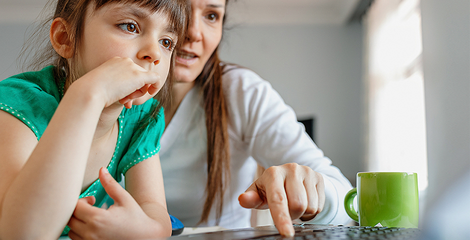 woman and child looking at laptop