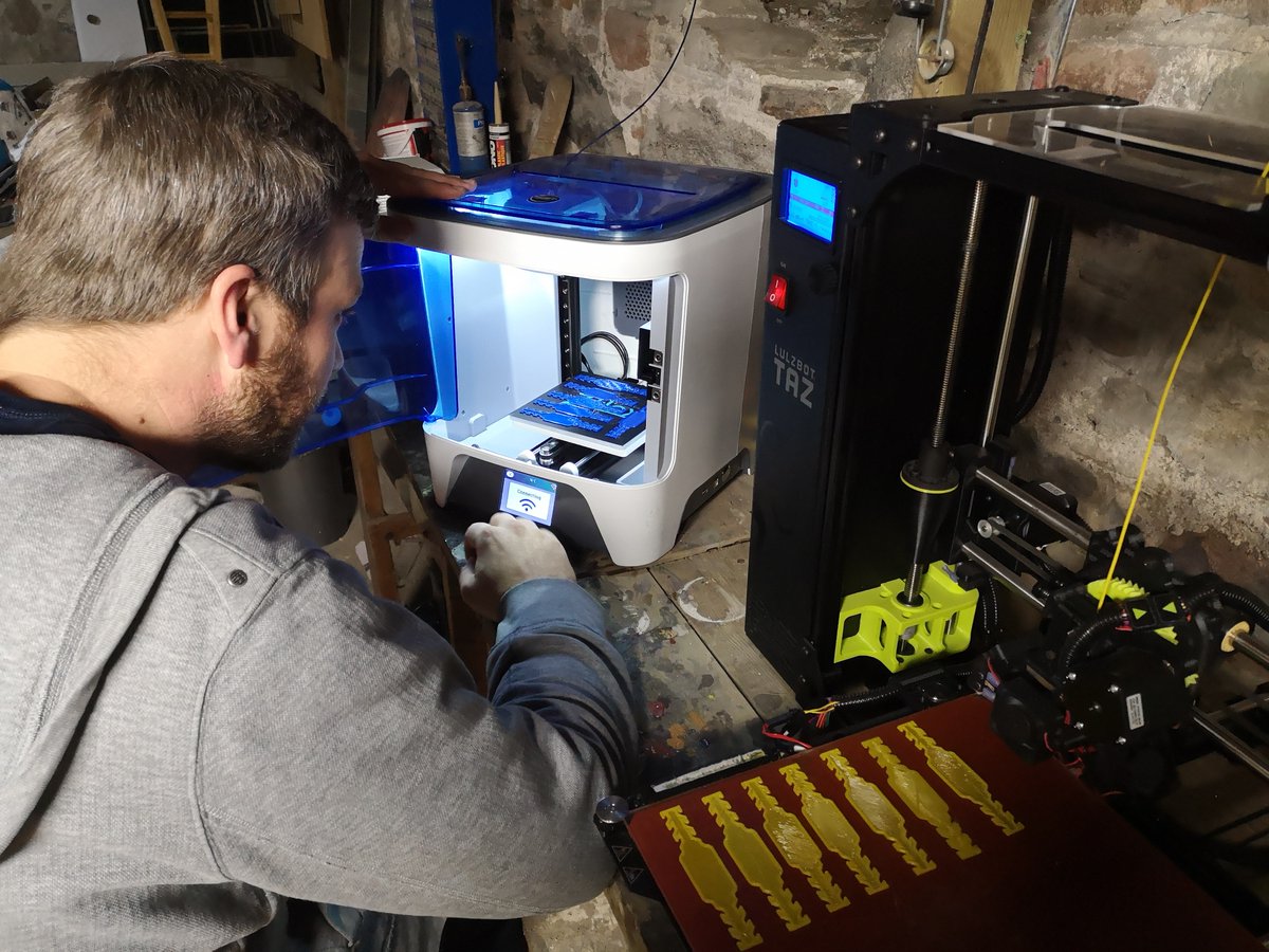 LibrElginCounty's tweet photo. Our branches are closed but our #3DPrinters have been redeployed to a good cause - to print mask clips &amp; support PPE items for our community. Here you see Aaron Devries printing with our @InkSmith3D Orbit. #sewstrong @stpl_library @StThomasChamber https://t.co/tDGbgV9RRQ https://t.co/aAtELzoVHl