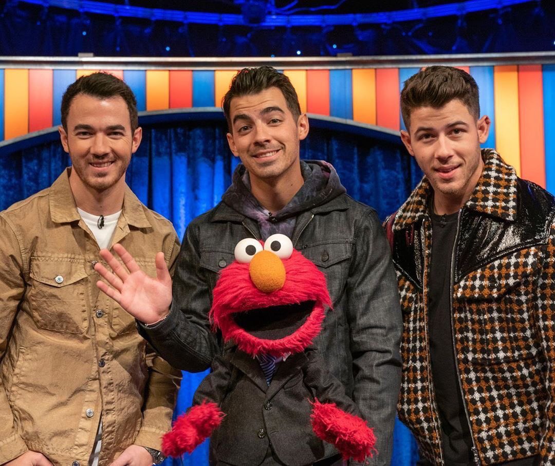 jonasbrothers's tweet photo. We’re so pumped to be joining our buddy @Elmo on his new talk show! Mark your calendars and don’t miss the #NotTooLateShow streaming May 27 on @hbomax 😎 https://t.co/YBTndn2Sk7