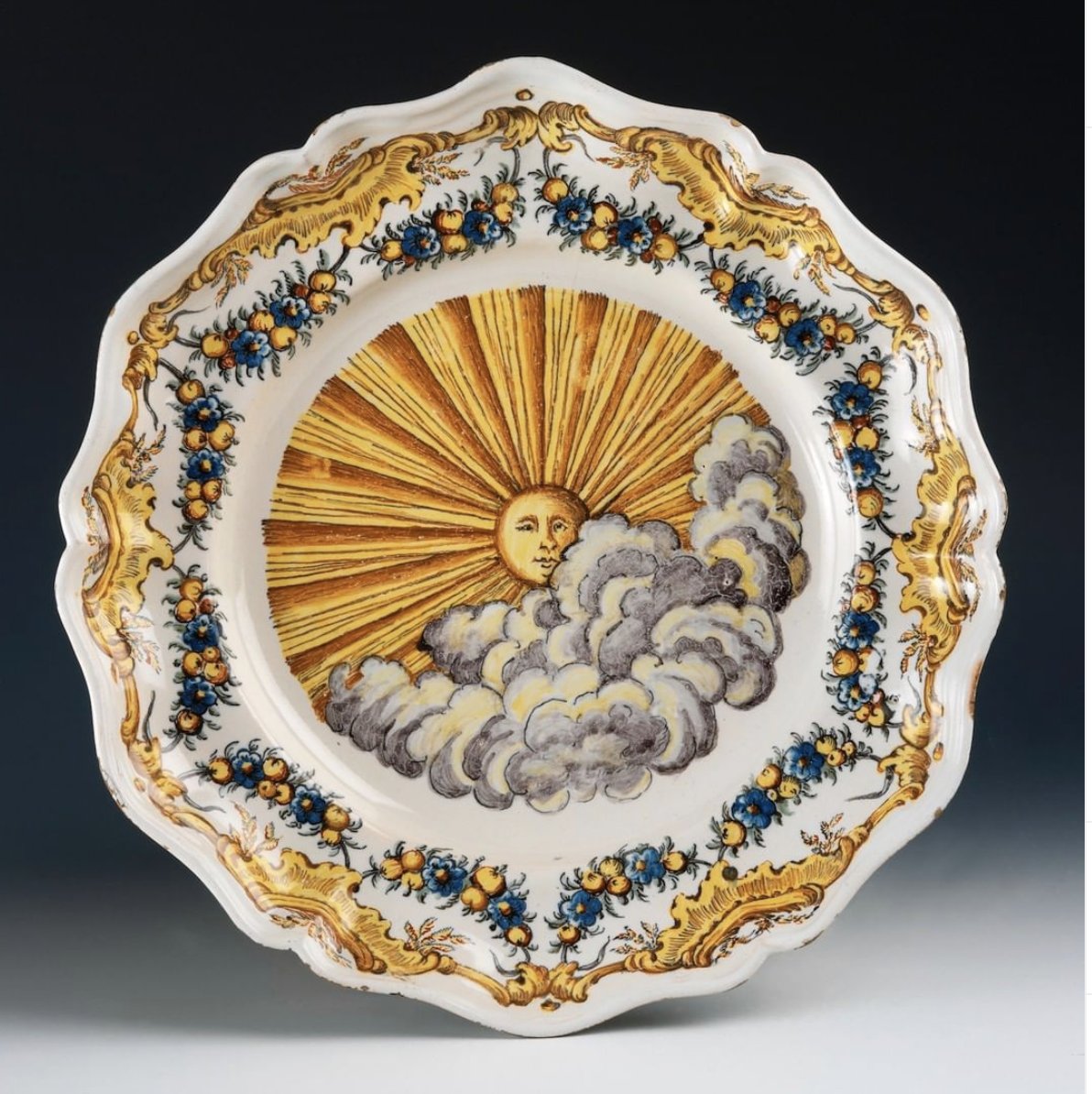 HSAmuseum's tweet photo. We're joining museums across the world today to share a little #museumsunshine with this eighteenth century plate with Sun and Clouds from the Royal Ceramic Factory of Alcora, Spain, ca. 1755-1775. https://t.co/hAhqlkKycq