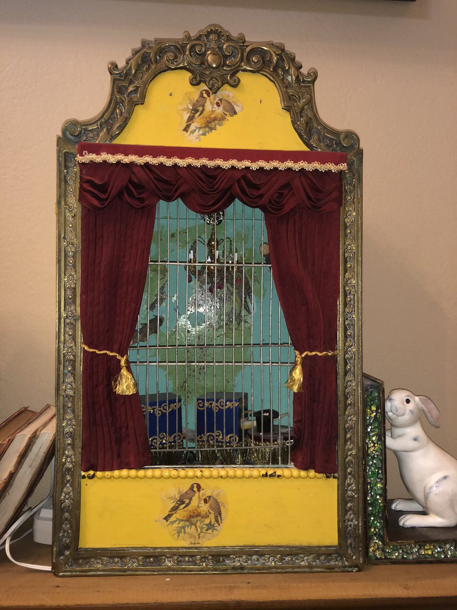 A taxidermy diorama of a canary cut in half by a killer magician.