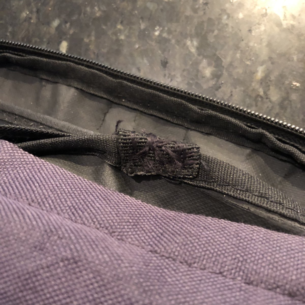 My sewing skills are self-taught from attaching patches to jean jackets. I pulled the handle through and folded it over so each stitch would pass through the handle twice and the bag seam once.