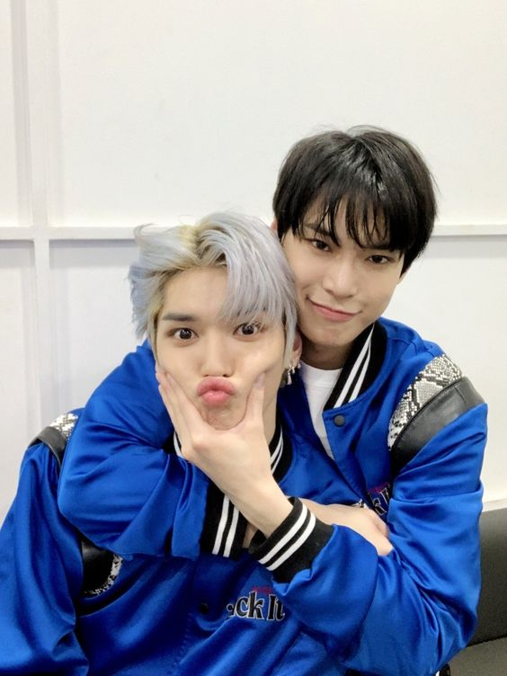 Taeyong the baby, being squeezed into a duck face