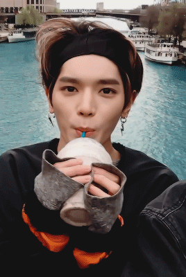 Taeyong the baby, sipping his starbucks drink in Chicago with two hands