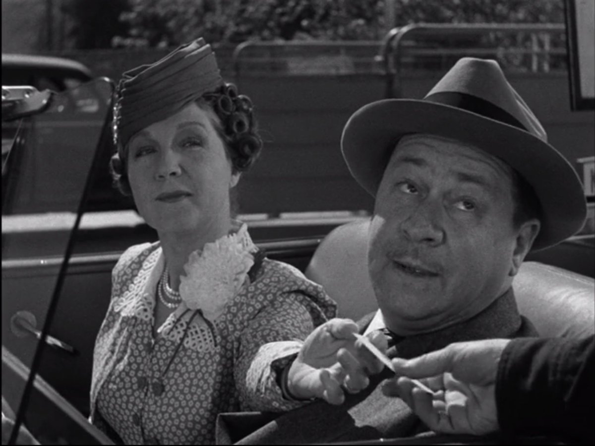 In this side-splittingly relatable moment, Benchley's wife is pushing Benchley to explain to the security guard about the book while he's all "Sorry that my wife's being a total bitch in your face but I WILL take her idea about getting that money because WOMEN, right??"