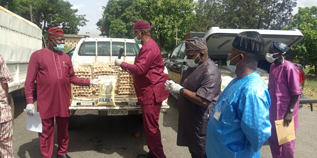 Oyo State Commissioner for Agriculture, Chief Jacob Ojemuyiwa receiving relief items donated by Ogun- Oshun RBDA on COVID 19 from MD/CEO,Olufemi Odumosu while the ED,(Engineering)Engr. Babalola and ED,  (P&amp;D) Engr. Adeoye look on.