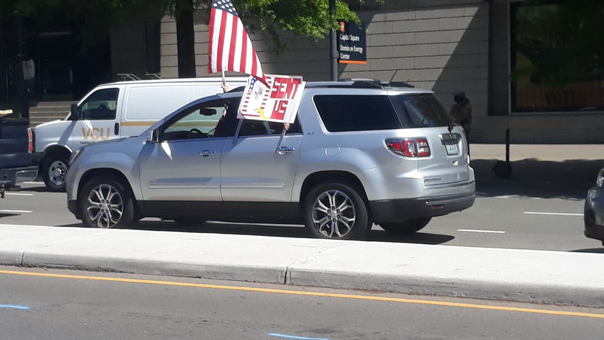 Car with sign that says Q SENT US