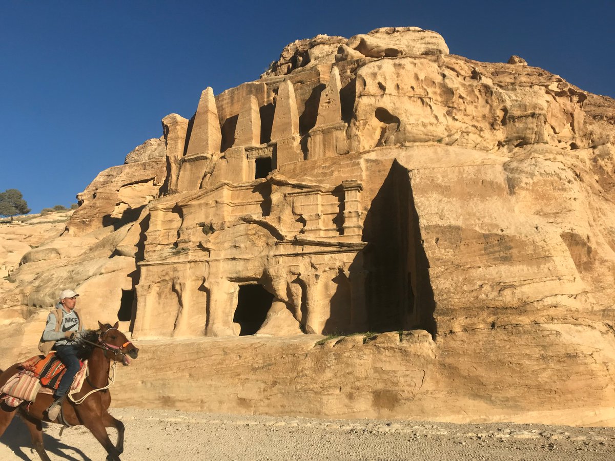 The approach to Petra takes you past several imposing monuments, including the Tomb of the Obelisks, and the 'Djinn Blocks', most likely unfinished tombs.  @PalExFund photo by Duncan Mackenzie / Francis Newton, 1910