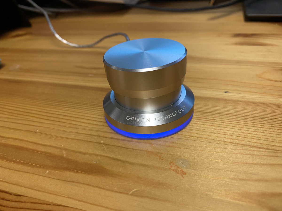 bapettit's tweet photo. Distance learning nerd moment! Found my old Griffin PowerMate programmable dial that I haven’t needed in years. Set it so a press toggles the mic mute in Meet and a long press toggles mic mute in Zoom! https://t.co/pHaWcJ91Yb