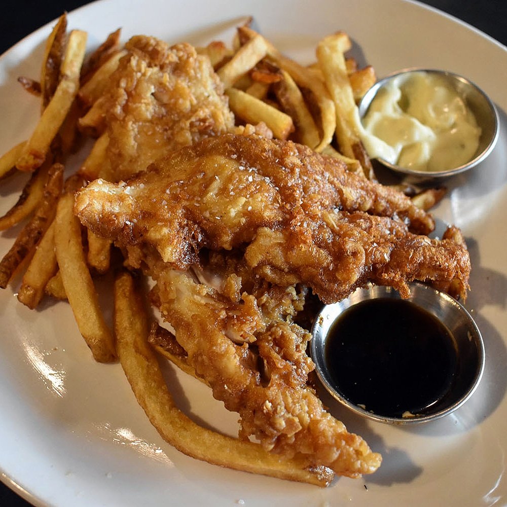 This BOMB Fish + Chips dish is available for take-out and delivery! 
Our house batter is made with White Labs Porter to create the perfect crispy &amp; flakey fried fish, served over our beloved lactobacillus fries, WLP 004 infused vinegar and caper aioli. ⁣🍻💛  #ashevillestrong