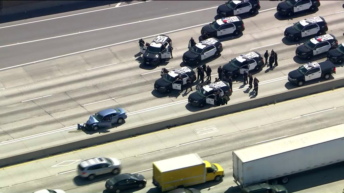 Authorities are in a standoff with a possibly armed suspect after a pursuit came to an end on the eastbound 91 Freeway at Cherry Avenue in Long Beach.