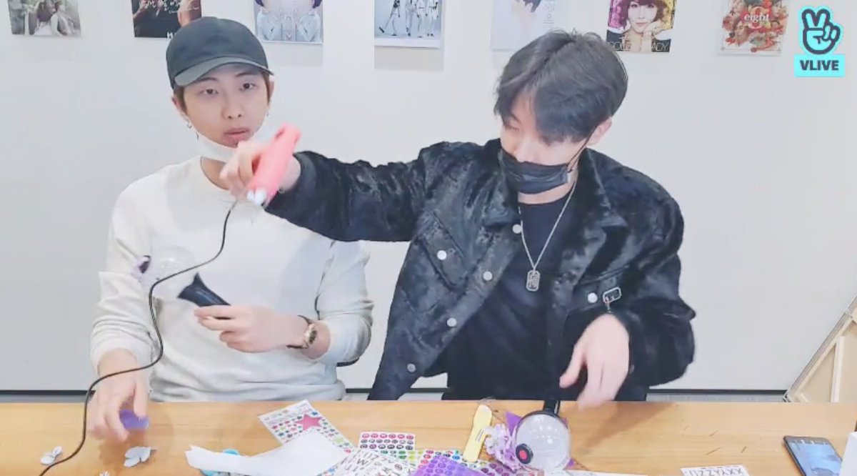 RM has finally pasted his pink flower on the top black knob of his army bomb, and says somewhat sadly that the glue has gotten rid of the life-like nature of it.He uh, then said with a cute and slightly whiny tone that he wants to stop now. H e h.