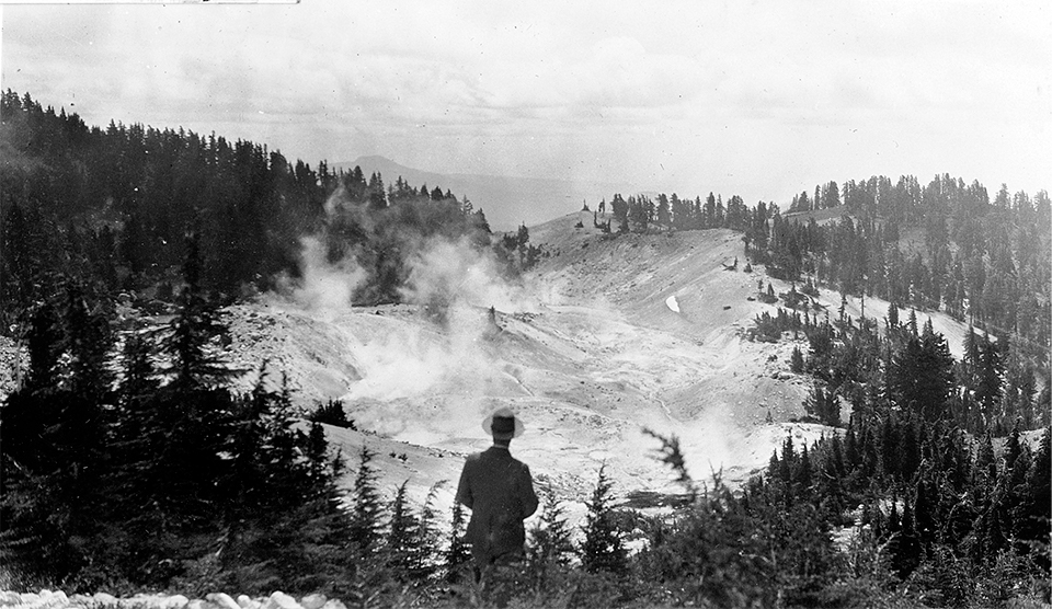 LassenNPS's tweet photo. The hydrothermal features at Bumpass Hell are constantly changing ♨️. So too are the boardwalk and visitors. In this photo from circa 1930-1934, a dapperly-dressed man enjoys a view of the basin before the first boardwalk was built. #NPSThrowbackThursday #FindYourVirtualPark https://t.co/LBu8W0i94T