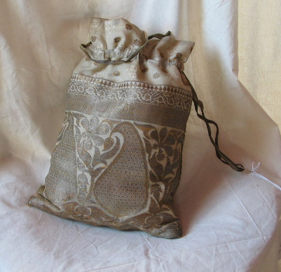 A beautiful piece in our collection, is this silk drawstring bag. The bag is not just fashionable but quite personal, as inside was found reels of knitting silk and steel knitting needles, upon which were the beginnings of a silk glove. The bag belonged to Emery Walker’s daughter