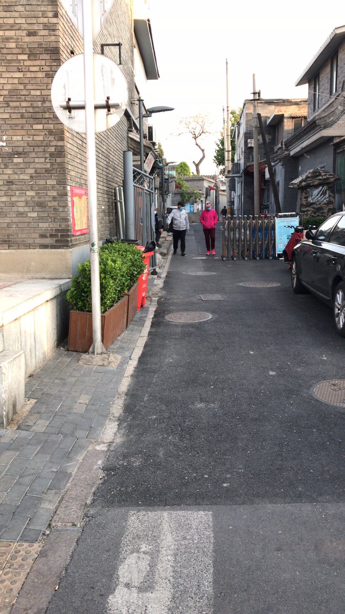 ...worry and I certainly don’t want to encourage conspiracies. The entrance to my hutong is still guarded (left), but the two security guards are so relaxed that they waved me through without bothering to check my temperature or my pass – the first time this has happened since...