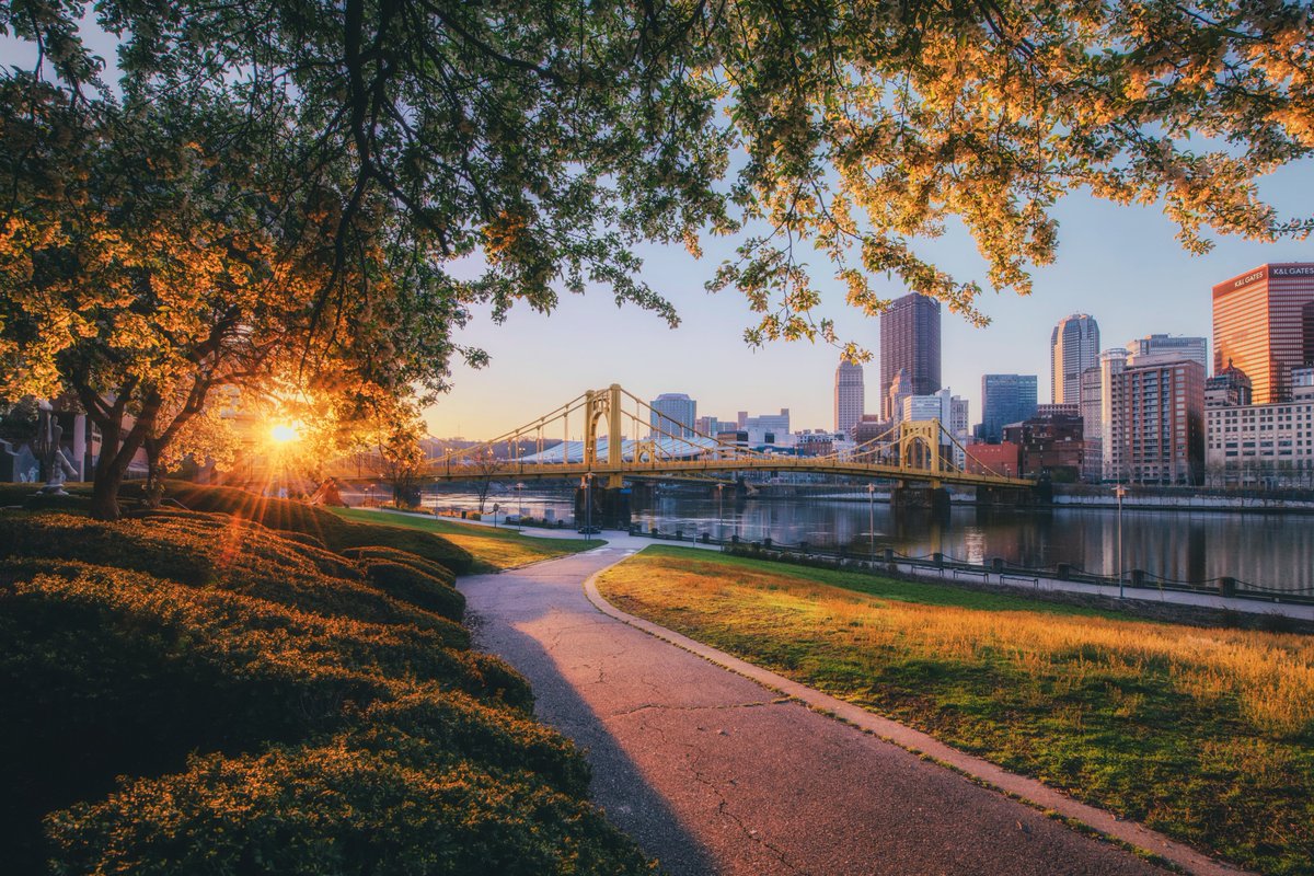 DaveDiCello's tweet photo. There are just so many different ways to frame #Pittsburgh with the trees along the North Shore, and this one from last weekend is up there as a favorite. With the sunlight illuminating the path, tree branches, and city, it really makes it look like you're walking into a painting https://t.co/ttmUywcyEZ