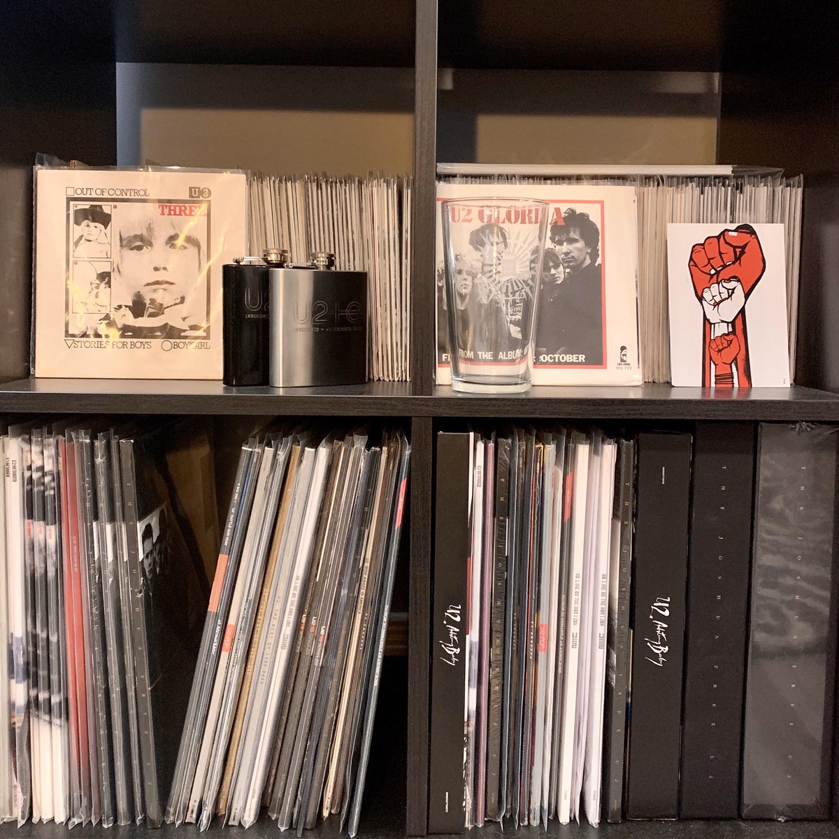 Photo 2: 7-inch singles across the top along with another SOI glass and one of the post cards from the SOE tour. New vinyl (albums) on the bottom (>2008) and boxed sets. Sitting on top of the 7-inches is some writing paper from the SOE promo campaign.
