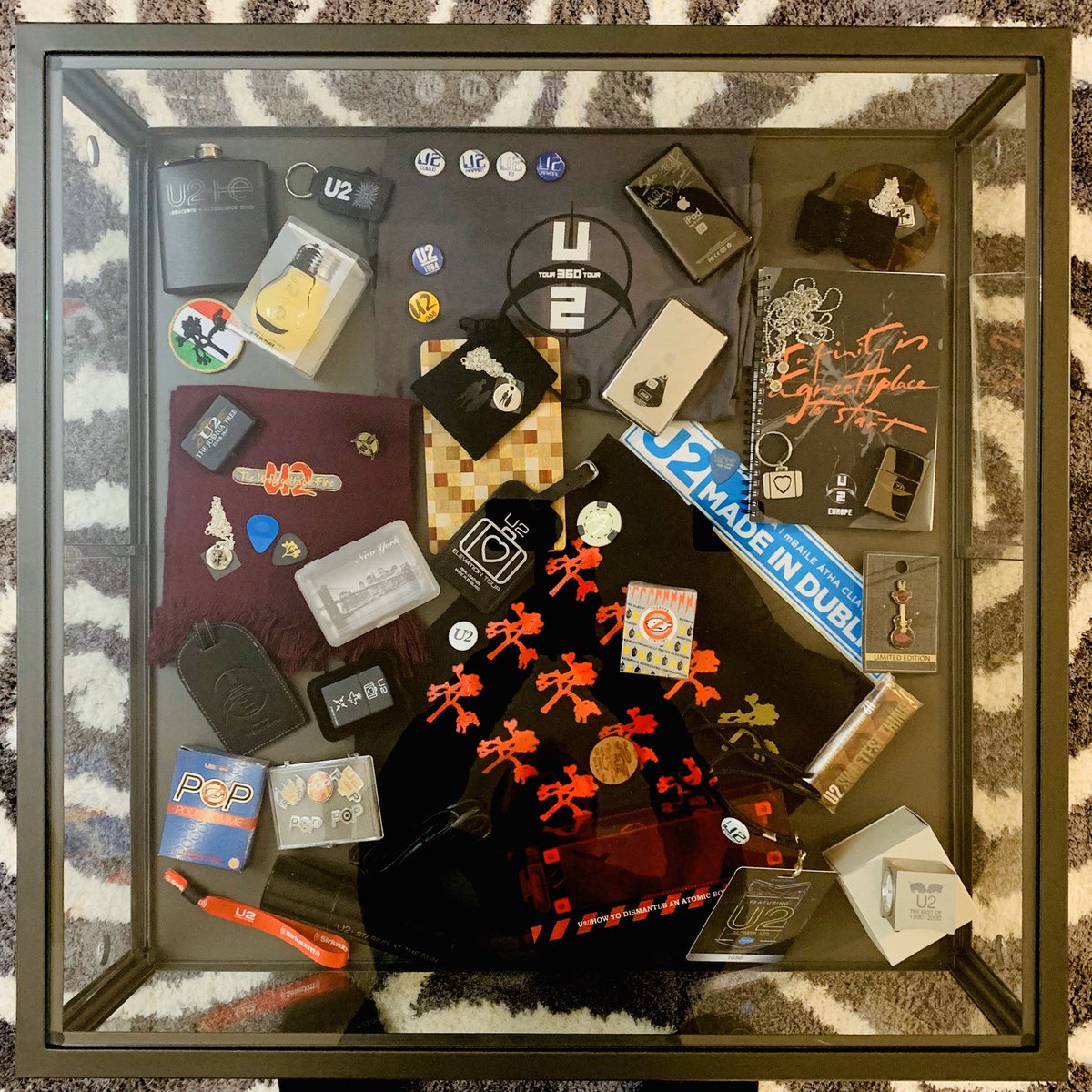 Photo 5: the coffee table: Various pins, lighters, condoms, passes, keychains, weather station, alarm clock, iPods, jewelry, luggage tags, chocolate bar, poker chips, picks and passes. Scarf from TUF tour, T-Shirt from Rose Bowl viewing party, bag from TJT2019 tour etc.