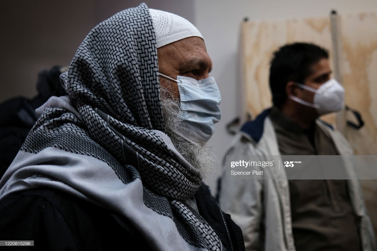 Muslim men participate in a brief funeral prayer service at a busy Brooklyn funeral home as
