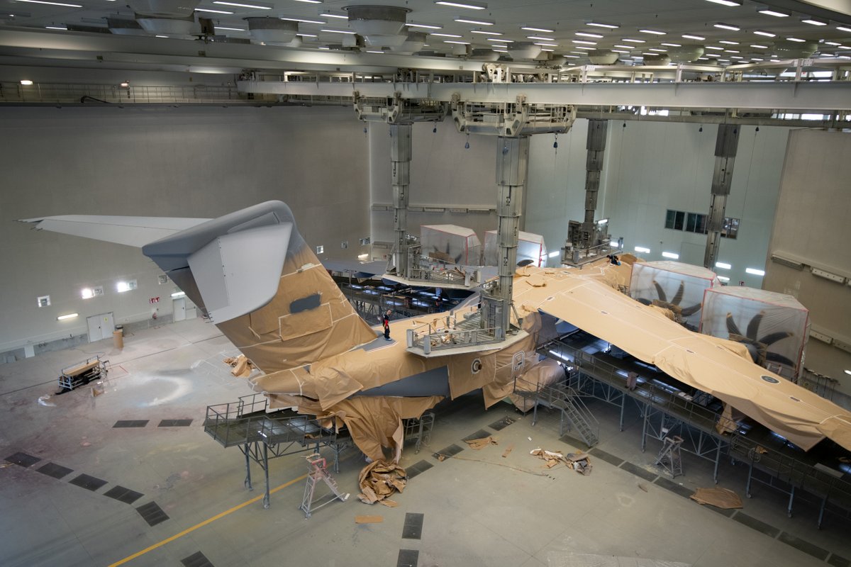 AirbusDefence's tweet photo. Once assembled, the first of a total of 7️⃣ #A400M for @BeAirForce 🇧🇪 enters the paint shop and starts going grey! 
Follow the painting process here 👇
Stay tuned…😉 https://t.co/wi2SmsWCDR