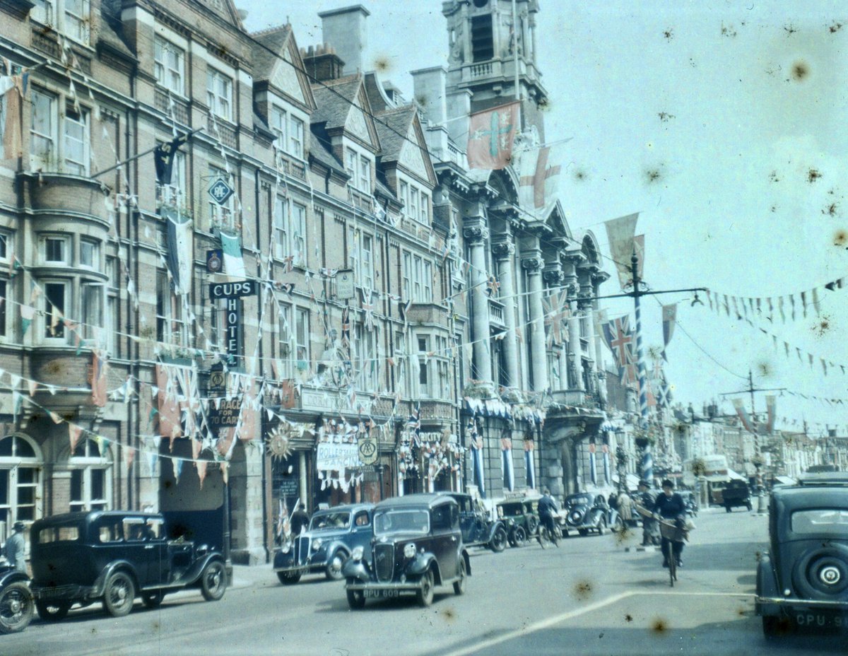 High Street, looking East. The old Corn Exchange building on the left (seen here advertising Rollerskating and Dancing) is now completely gone. 9/14