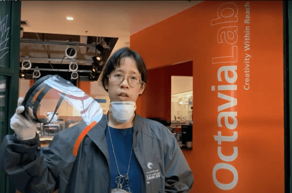 libarian holding a 3-d printed face shield