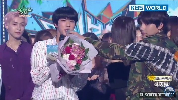 Aww he is a sweetheart... He was helping Jin to speak by holding the mic