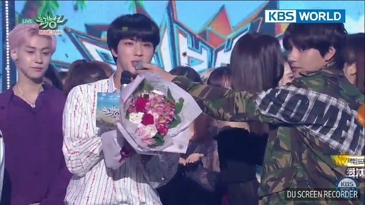 Aww he is a sweetheart... He was helping Jin to speak by holding the mic