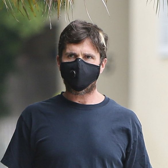 Christian Bale picking up a to-go order as his mask struggles to cover his chin