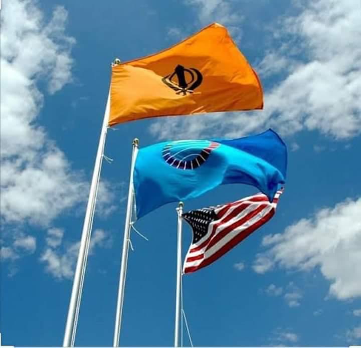 harbhajan_singh's tweet photo. Nishan Sahib has been hoisted beside the U S flag for one month to honour the Sikh community towards the pandemic, in the city 
of Holyoke U S A https://t.co/k6roM6uLRO