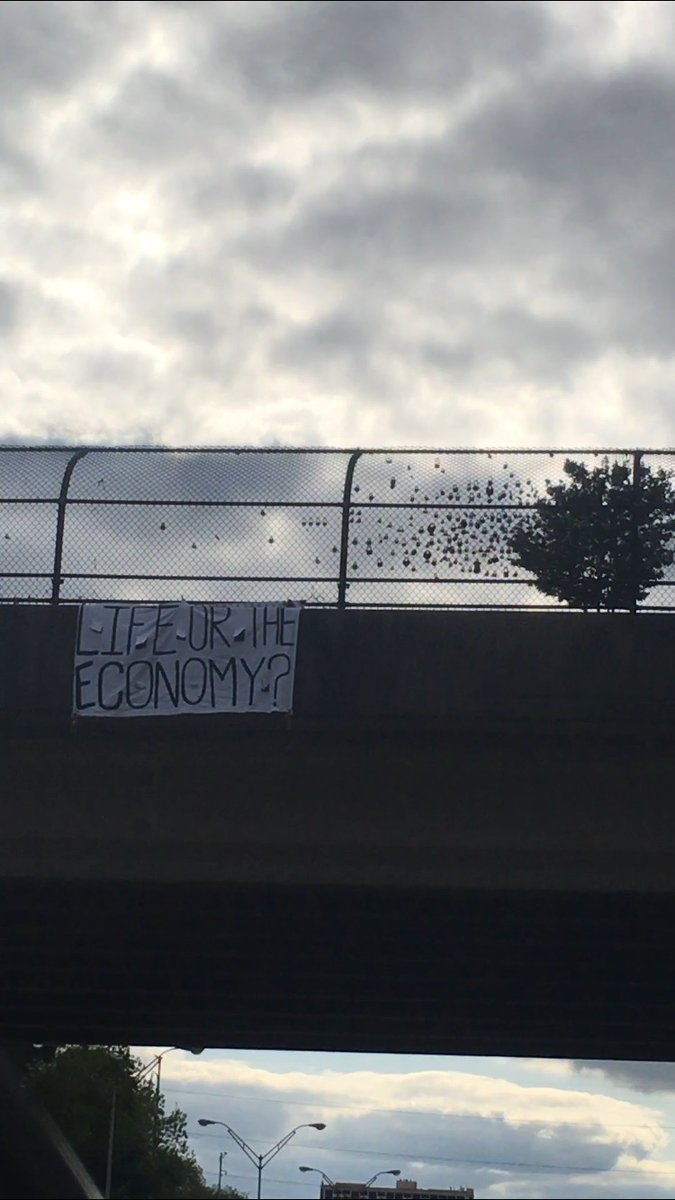 AllOutAtlanta's tweet image. LIFE OR THE ECONOMY? Banner hung over the interstate in Atlanta, as protest against Kemp's reopening of the state drove by.