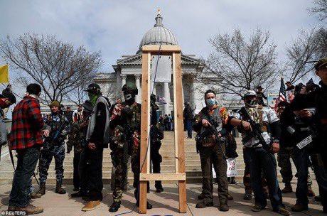 From the stay-at-home orders “protest” yesterday in Madison, Wisconsin: The obligatory camouflage, long guns, and a makeshift guillotine, all routinely trotted out by gun extremists across the US to threaten lawmakers’ lives.  #wileg