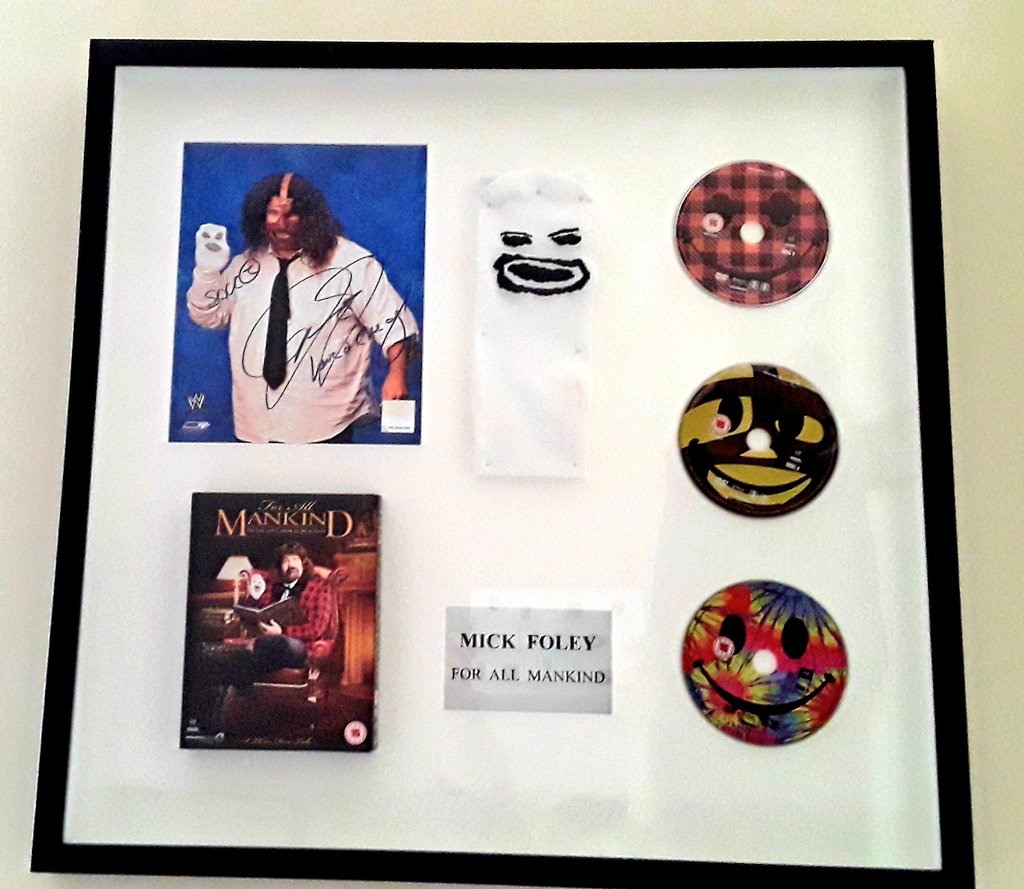Quick question for you all....What's your favourite piece of wrestling merchandise that you own?Could be a shirt, a personal 8x10, a signed piece of memorabilia? etcMine is this Mick Foley framed piece that I won in a competition.Which now hangs proudly on my wall.