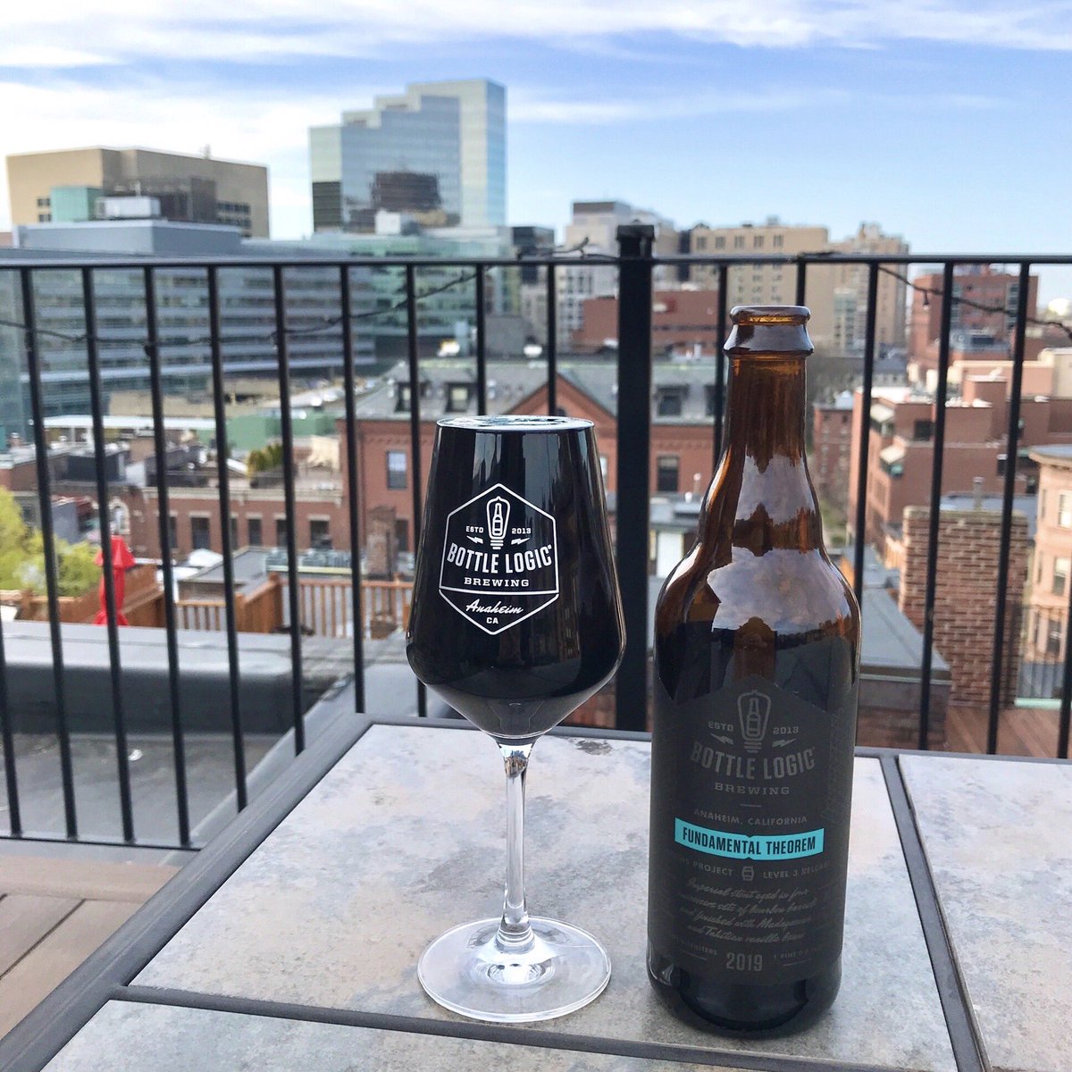 Resuin's tweet image. Enjoying a full bottle of @BottleLogicBrew Fundamental Theorem on my roof deck. Cause what else can I do. #quarantine #craftbeer
