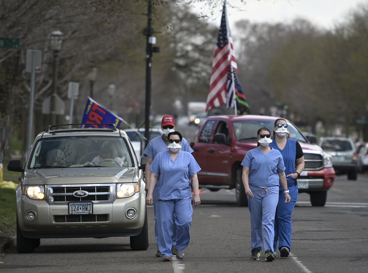 Shortly after the protest started, a group of four counter-protesters arrived, donning medical scrubs. Three of them say they work as emergency nurses at a local ER.
