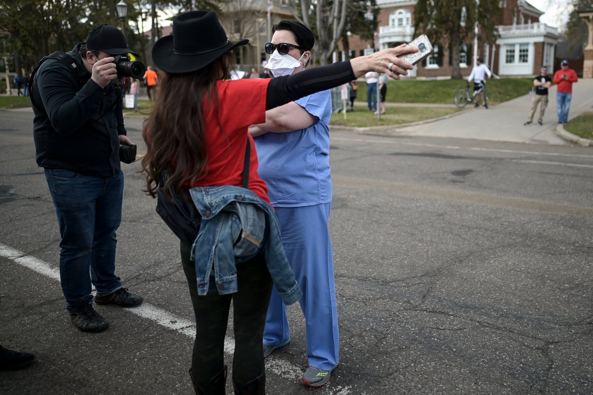 They were met with cheers and jeers, with some protestors thanking them for their work and others claiming they were crisis actors looking for a viral moment.