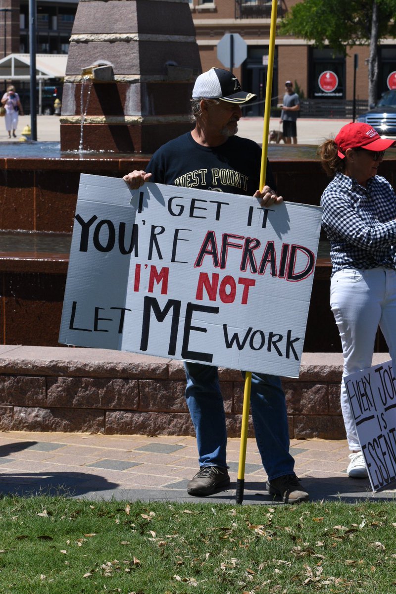 Signs include two that read, “I prefer dangerous freedom over peaceful slavery,” and “all lives matter.”  @wfaa